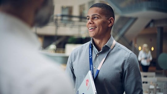 Man talking to colleagues smiling